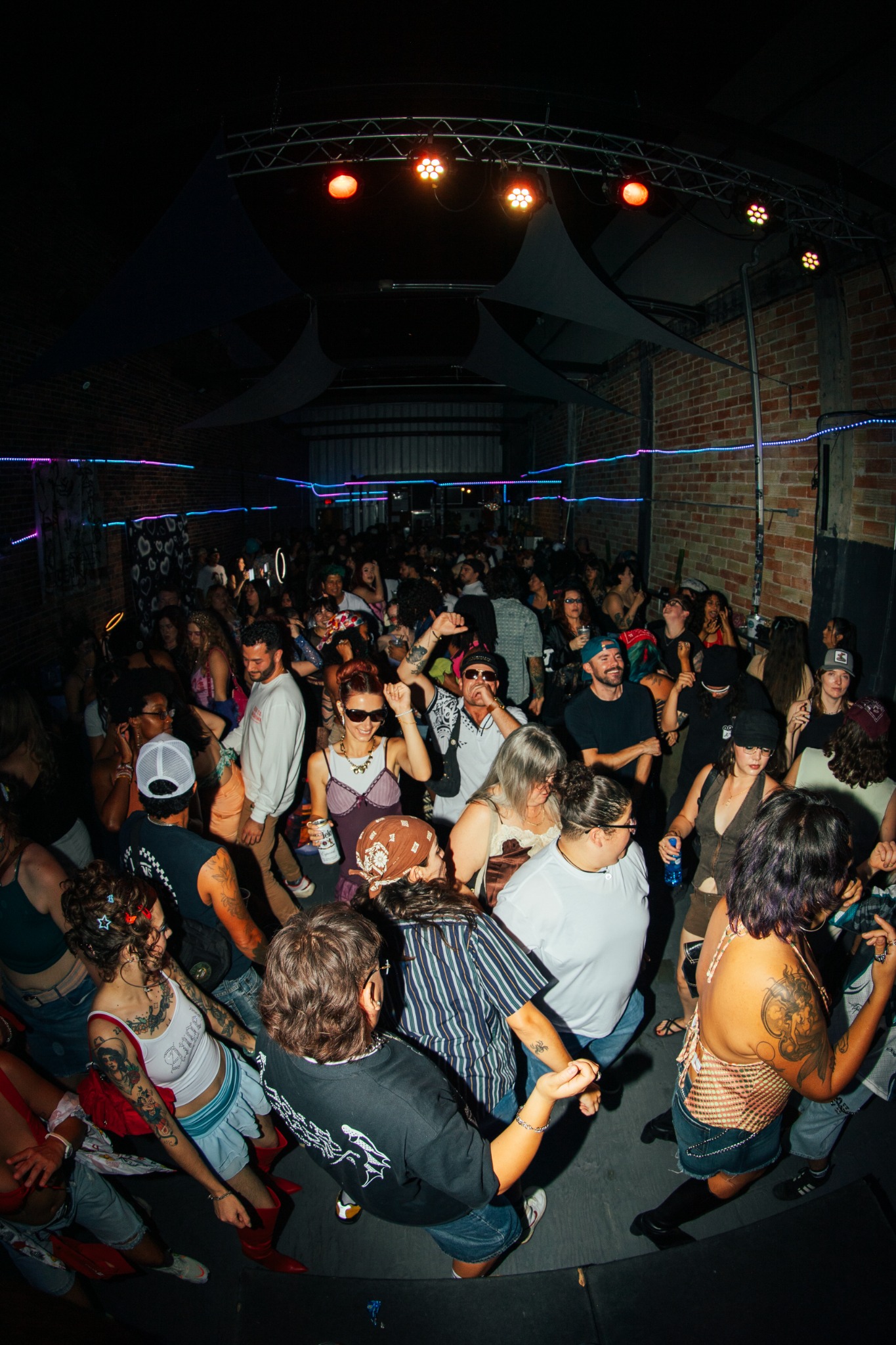 Crowd dancing in a warehouse style venue