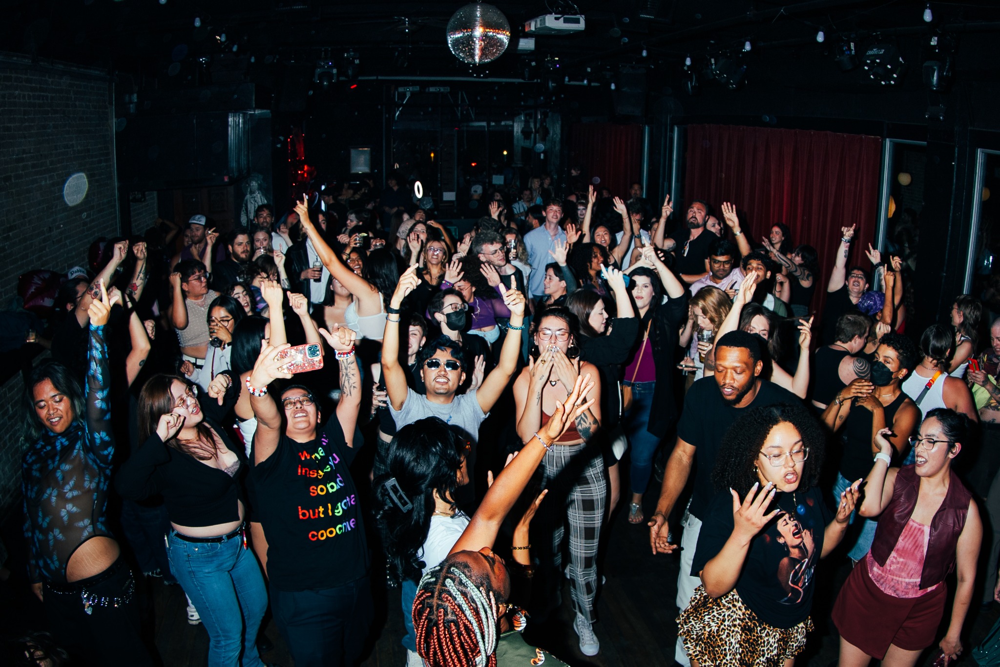 Crowd dancing at a TOMBOY event